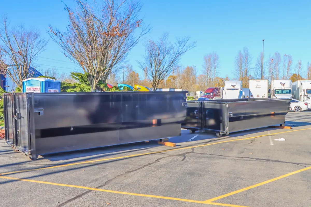 Professional dumpster rental service with roll-off container on residential driveway in Pittsburg